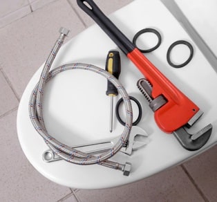 Toilet with plumbing tools